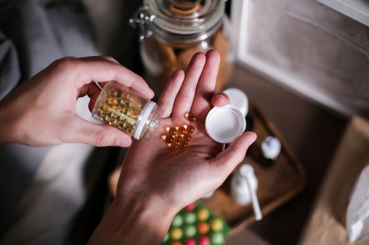 Hands holding supplement capsules for an amino acid guide