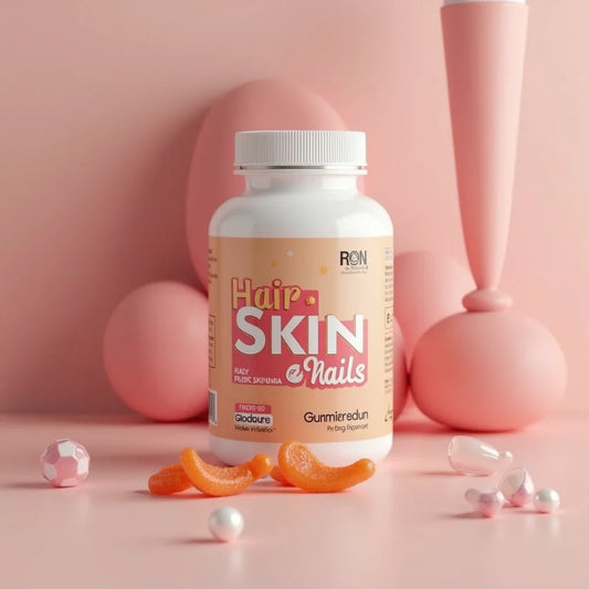 Hair skin and nails supplement bottle with orange gummies on a pink background