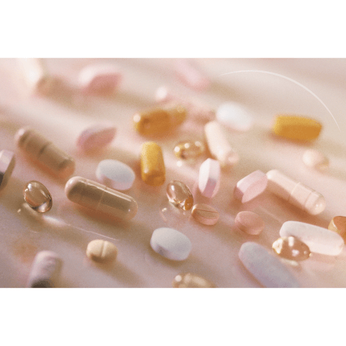 variety of sleep supplement pills and capsules in soft natural light on a neutral surface